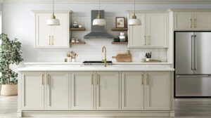 Modern white kitchen with matching cabinets and walls, featuring brass hardware.