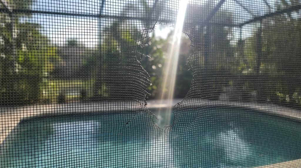 Pool screen enclosure showing heat damage near reflective windows